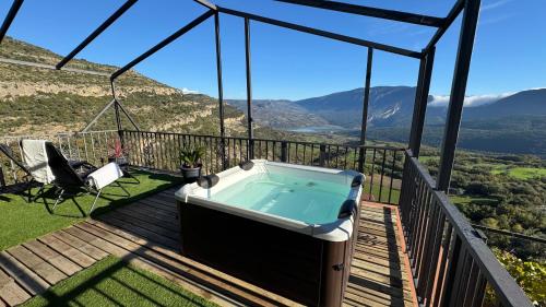 a hot tub on a deck with a view at Cal Foraster in Estorm