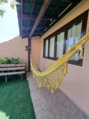 a hammock on the side of a house at Pousada Happy 300m da Praia do Itaguaçú in São Francisco do Sul