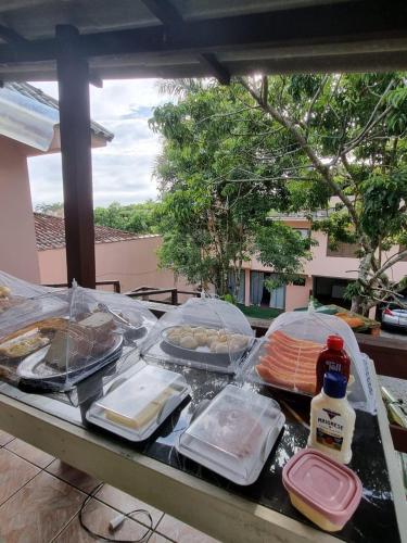 a table with food on top of a table at Pousada Happy 300m da Praia do Itaguaçú in São Francisco do Sul