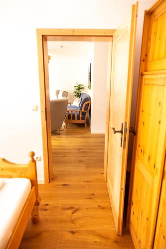 a hallway with a door open to a living room at Fewo Schönes Ammertal in Oberammergau