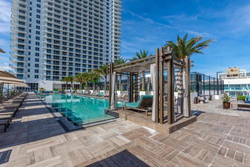 a pool at the resort with a gazebo at Amazing Apartments at H Beach House in Hollywood