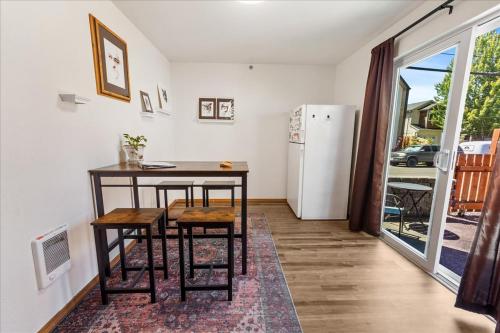 a kitchen with a table and chairs and a refrigerator at Sunstone House in Portland