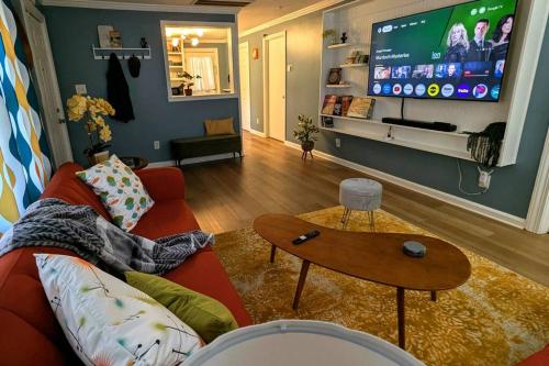 a living room with a red couch and a tv at Kitchen, Laundry & Fenced Yard in New Bern