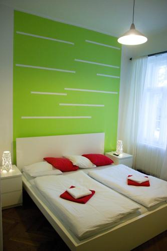 a bedroom with a bed with red pillows on it at Budget Apartment in Prague