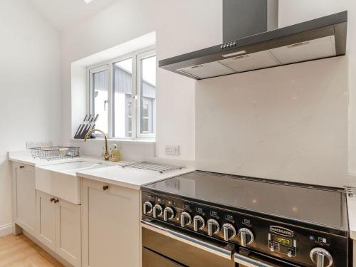 a kitchen with a stove and a sink at The Old Chapel in Gainsborough