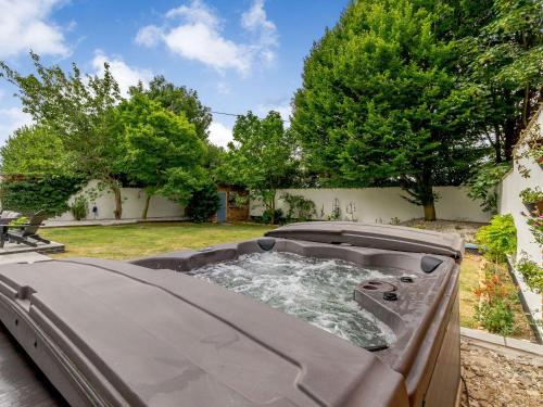 a hot tub in a yard with trees at The Old Chapel in Gainsborough