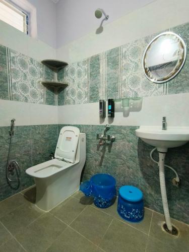 a bathroom with a toilet and a sink at Servostay Newly Launched Luxury Fully Furnished 1 BHK Flats in Tirupati
