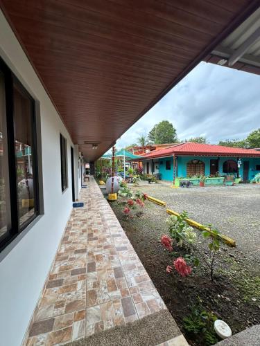 a walkway leading to a building with a building at Hotel Sueños de María in Uvita