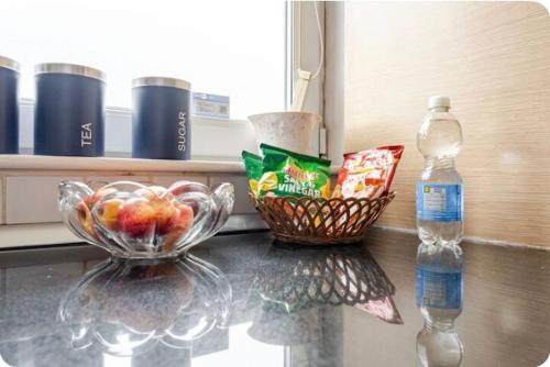 a bowl of fruit and a bottle of water on a counter at Amazing River view 2 bedroom apartment, sleeps 6 , balcony and parking in London
