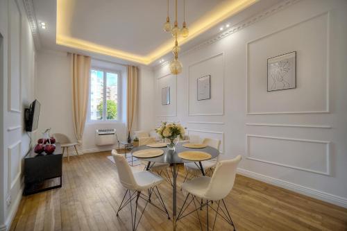 une salle à manger avec une table et des chaises blanches dans l'établissement Spacieux et confortable 3 pieces A2B248, à Cannes