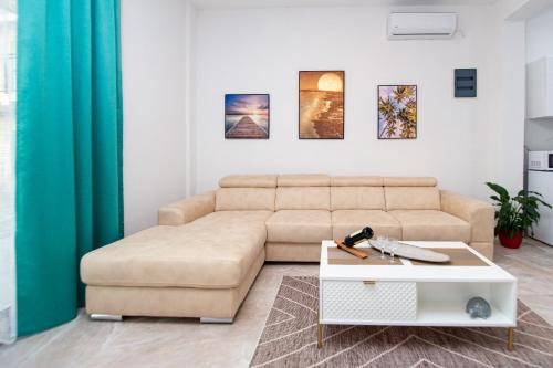 a living room with a couch and a table at Stone Villa with pool Montenegro Star in Kaluđerac