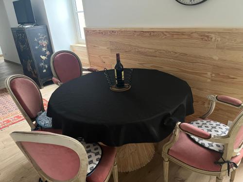 a table with a black table cloth and chairs at Au bord du gave in Laruns