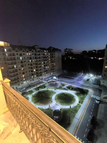 a view of a courtyard from a balcony at night at Sea side Bulvar in Sumqayyt