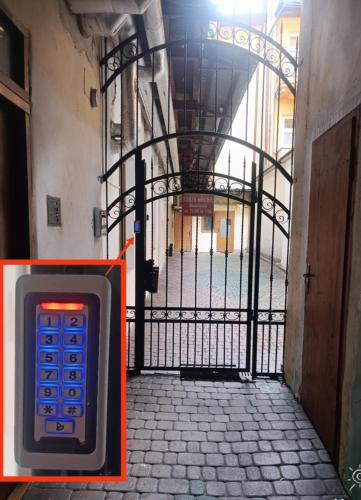 a gate with a cell phone in front of a building at Apartament Alibi in Przemyśl