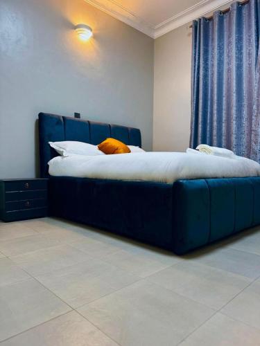 a blue bed in a bedroom with a blue couch at 1 bed-uganda-2people-wifi-closetocity-parking in Makerere