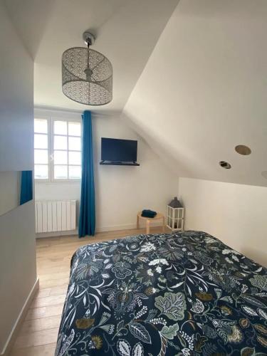 - une chambre avec un lit king-size et un couvre-lit bleu dans l'établissement Maison spacieuse avec jardin à Thiron-Gardais, à Thiron-Gardais