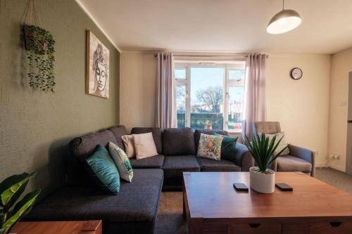a living room with a couch and a table at The Eastmount - Stunning 3 bed house in Hull