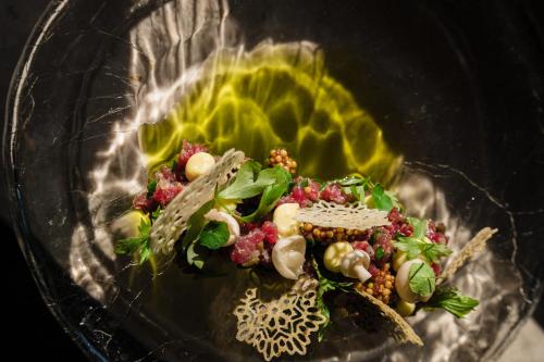 a plate of food with vegetables on a table at Złoty Groń Resort & Spa in Istebna