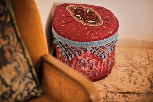 a red container is sitting in a box at Chez Liart 2 in Fasano