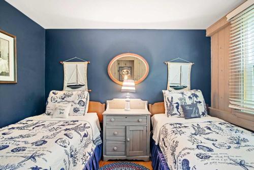 two beds in a room with blue walls at 5 Min Walk to Swimmable Mill Pond Dog Friendly in Orleans