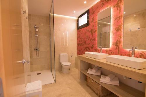 a bathroom with a shower and a sink and a toilet at Serenity Amadores in Puerto Rico de Gran Canaria