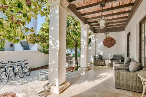 a porch with bikes on the wall of a house at Bella Cottage in Rosemary Beach