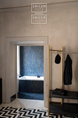 a bathroom with a bath tub in a room at Unicum Suite Grande Archivio Napoli Centro Storico in Naples