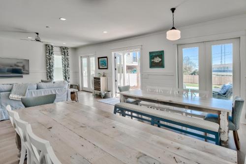 a living room with a wooden table and chairs at Gilligan's Island in Inlet Beach