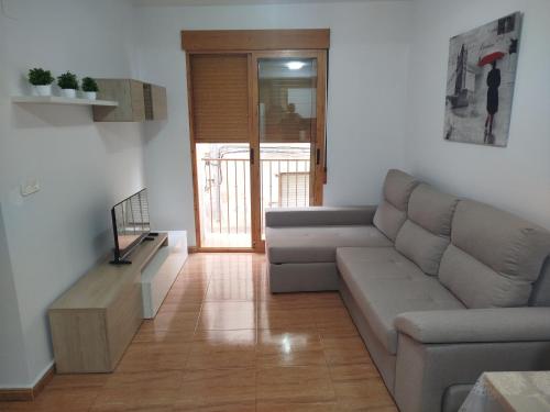 a living room with a couch and a table at Los tres balcones in Caravaca de la Cruz