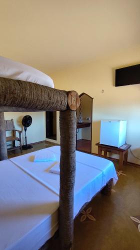 a bedroom with a bunk bed with a table and a laptop at Espaço Akronos Residence in Canoa Quebrada