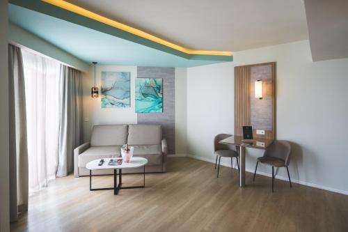 a living room with a couch and a table at Riu Palace Antillas - Adults Only - All Inclusive in Palm-Eagle Beach