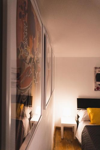 a bedroom with a bed and a table with a lamp at Old Town Nest in Civitavecchia in Civitavecchia