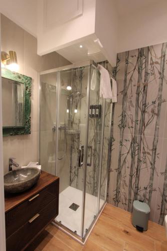 a bathroom with a shower with a sink at La Dolce Vita Civitavecchia in Civitavecchia
