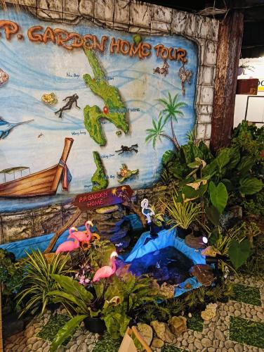 a mural of a garden playsort with animals and plants at P P Garden Home Bungalow in Phi Phi Don