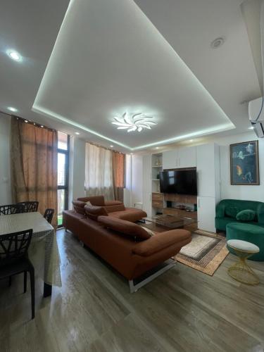 a large living room with a couch and a television at BBImmo APPART HOTEL in Dakar