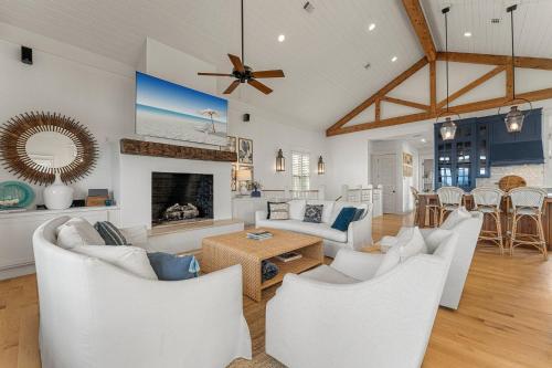 a living room with white furniture and a fireplace at Hope Town Pearl Cottage in Rosemary Beach
