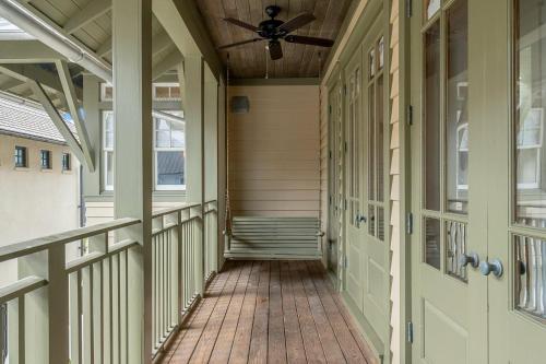 a porch of a home with a ceiling fan at Hope Town Pearl Cottage in Rosemary Beach