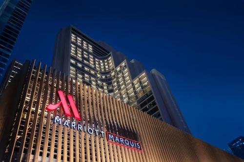 a tall building with a sign on top of it at Bangkok Marriott Marquis Queens Park in Bangkok