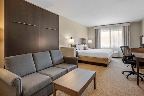 a hotel room with a couch and a bed at Best Western Plus The Inn at Hells Canyon in Clarkston
