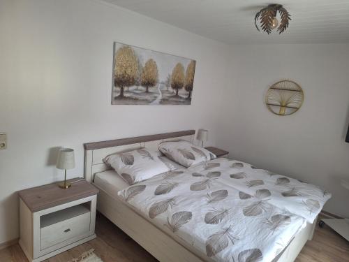a bedroom with a bed and a picture on the wall at Ferienwohnung in der Korbstadt Lichtenfels in Lichtenfels