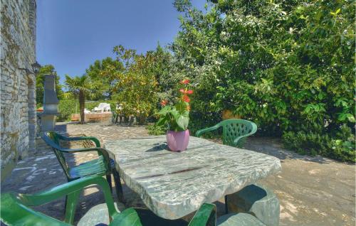 a table with a vase of flowers on it at Cozy Home In Kastel With Wifi in Kaštel