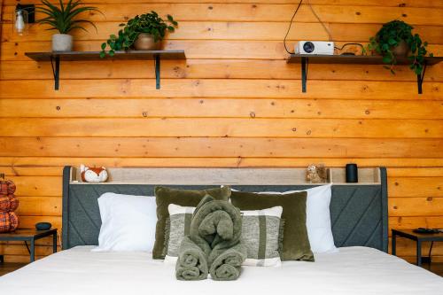 a bedroom with a bed with a wooden wall at The Ellijay Turtle House in Ellijay