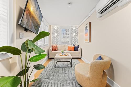 a living room with a couch and a chair at Surrey Beach House in Ventnor City