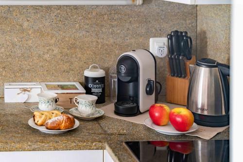 a kitchen counter with a coffee maker and two plates of food at Apartment Chesa Erica 65m2 with private garden in Silvaplana