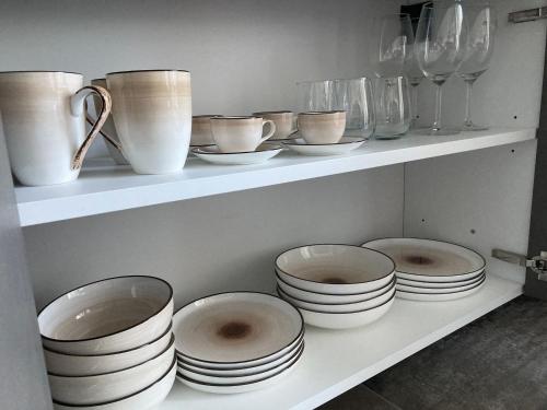 a shelf filled with plates and bowls and vases at Maso Valèr - Agritur in Tassullo