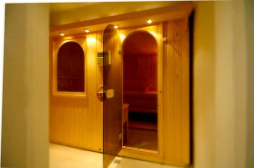 a hallway with a door and a mirror in a room at Philippos Xenia Hotel in Serres
