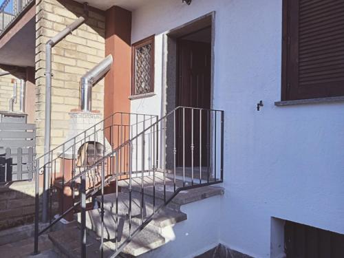 a dog sitting on the porch of a house at Alloggio turistico IL SOLE in Sutri