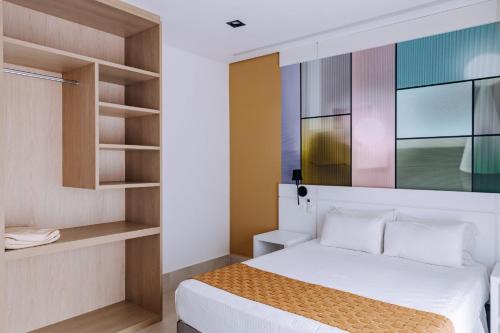 a bedroom with a bed and shelves at Vistabela Resort & Spa in São Sebastião