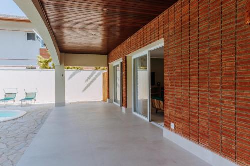 an external view of a house with a brick wall at Vistabela Resort & Spa in São Sebastião