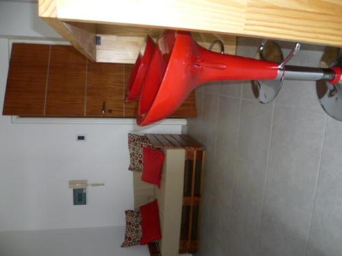 a pair of red scissors hanging from a kitchen counter at Departamento Corrientes in Villa María